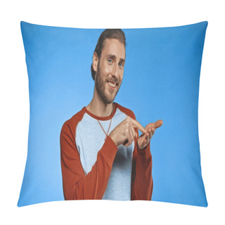 Personality  Excited Young Man Pointing With Finger At Hand While Showing Text Me Gesture On Blue Pillow Covers