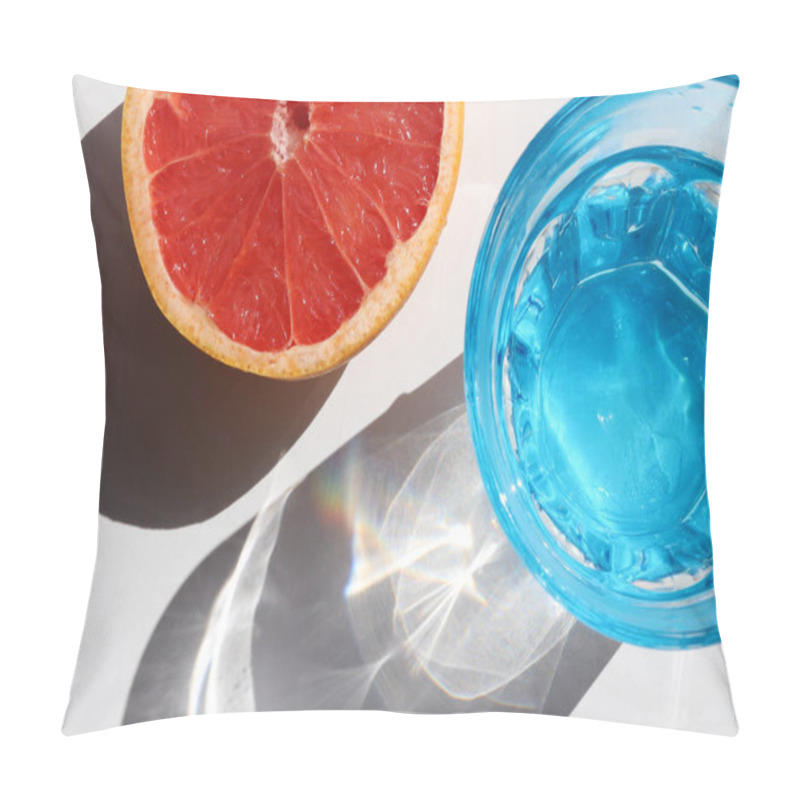 Personality  Summer still life with blue glass of cold water and half of grapefruit on white table background. Top view, copy space. Hard light, shadow pillow covers