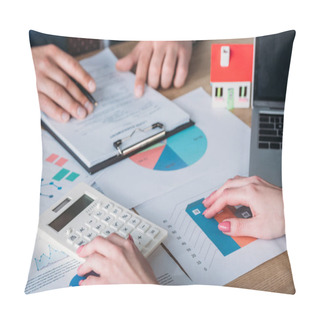 Personality  Partial View Of Man Studying Loan Agreement And Businesswoman Using Calculator While Sitting At Workplace With House Model, Graphs And Charts Pillow Covers