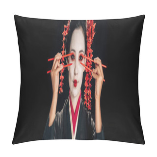 Personality  Beautiful Geisha In Black Kimono With Red Flowers In Hair Holding Chopsticks Near Eyes Isolated On Black, Panoramic Shot Pillow Covers
