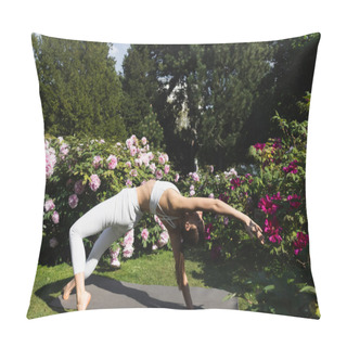 Personality  Slim Woman In White Sportswear Practicing Wild Thing Yoga Pose Near Blossoming Plants In Park Pillow Covers