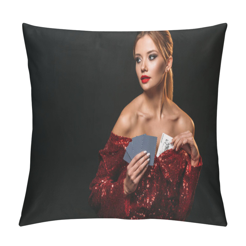 Personality  attractive girl in red shiny dress hiding joker card in dress and looking away isolated on black pillow covers