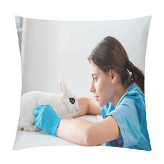 Personality  Side View Of Attentive, Positive Veterinarian Examining Cute White Rabbit Sitting On Table Pillow Covers