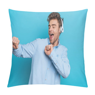 Personality  Cheerful Young Man Dancing In Wireless Headphones On Blue Background Pillow Covers
