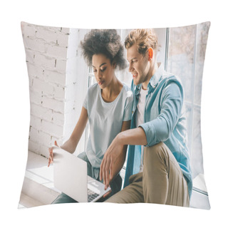 Personality  Multiracial Couple Looking At Laptop Screen While Sitting By Window Pillow Covers