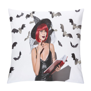 Personality  Thoughtful Girl In Black Witch Halloween Costume With Red Hair Holding Book Near White Wall With Decorative Bats Pillow Covers