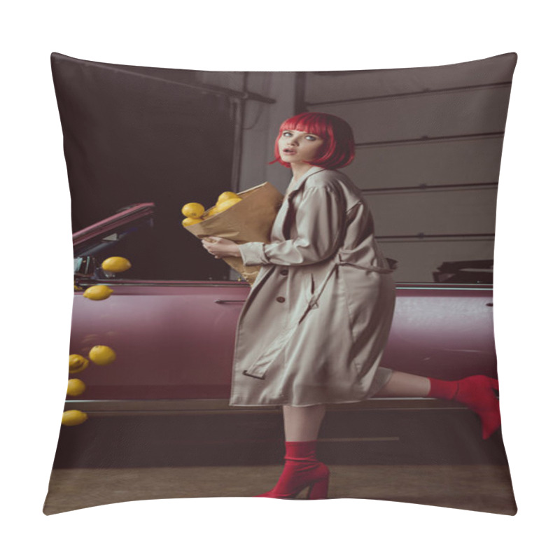 Personality  girl in red wig and stylish trench coat holding paper bag with falling lemons near retro car  pillow covers