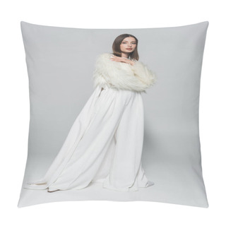 Personality  Full Length Of Trendy Woman In Totally White Outfit And Faux Fur Jacket Posing On Grey Pillow Covers