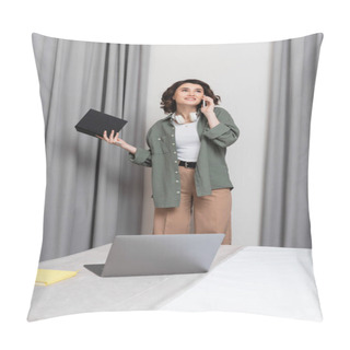 Personality  Pleased Woman With Wavy Brunette Hair And Wireless Headphones Holding Notebook, Looking Away And Talking On Smartphone Near Grey Curtains And Laptop With Notepad On Comfortable Bed In Hotel Room Pillow Covers