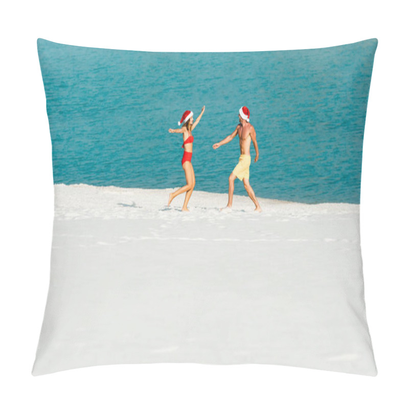 Personality  sexy girlfriend and boyfriend in santa hats with outstretched hands on beach in Maldives  pillow covers