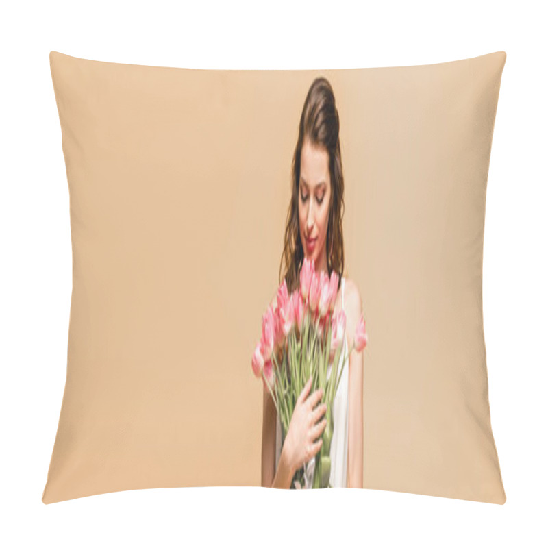 Personality  panoramic shot of happy girl holding pink tulips isolated on pink pillow covers