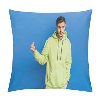 Personality  Young Confident Man Showing How Much Money Gesture While Holding Hand In Pocket On Blue Background Pillow Covers