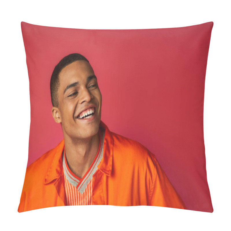 Personality  portrait of stylish and positive african american guy in orange shirt looking away on red background pillow covers