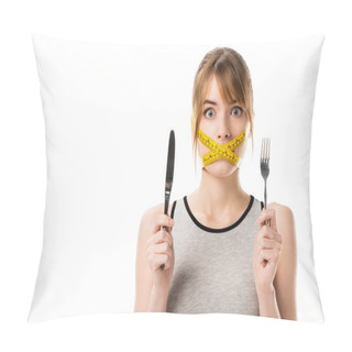 Personality  Shocked Young Woman With Measuring Tape Tied Around Her Mouth Holding Fork And Knife Isolated On White Pillow Covers