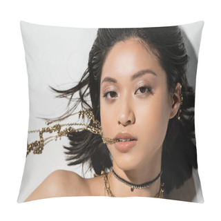 Personality  Top View Of Young Asian Woman With Short Brunette Hair Holding Golden Jewelry In Mouth While Looking At Camera And Lying On Grey Background, Everyday Makeup, Wet Hairstyle  Pillow Covers