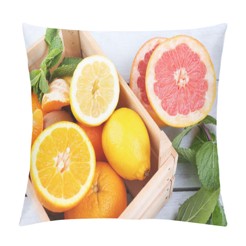 Personality  Fresh citrus fruits with green leaves in wooden box on color wooden background pillow covers