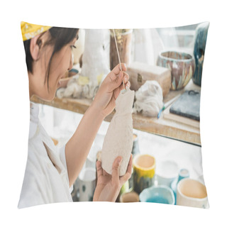 Personality  Side View Of Smiling Blurred Young Asian Female Artist Holding Wooden Stick And Clay Product While Working In Blurred Pottery Class At Background, Pottery Studio With Artisan At Work Pillow Covers