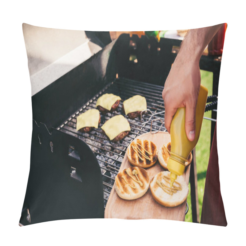 Personality  Chef adding mustard to burgers cooked outdoors on grill pillow covers