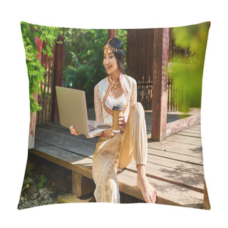Personality  Happy Indian Woman In Ethnic Wear With Laptop And Takeaway Coffee In Wooden Alcove In Park Pillow Covers