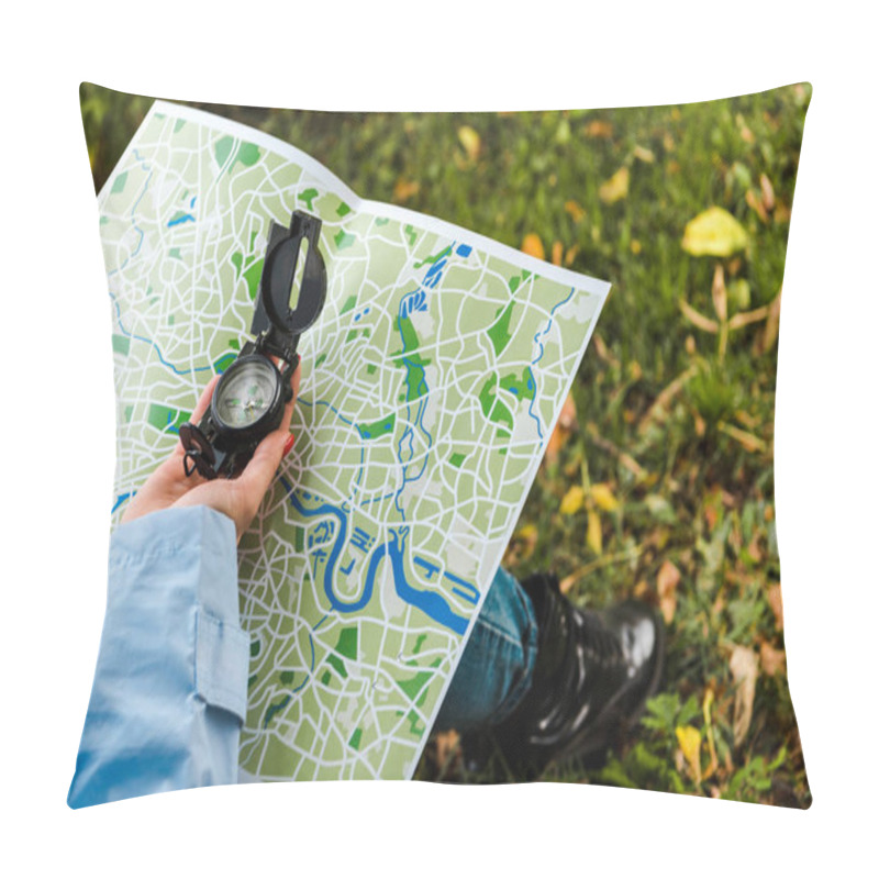 Personality  cropped view of woman holding map and compass outside  pillow covers