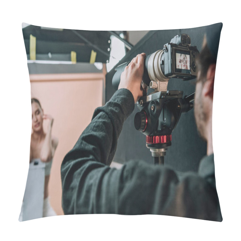 Personality  Selective focus of cameraman and beautiful model working in hoto studio pillow covers