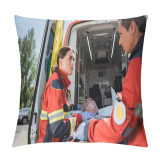 Personality  Selective Focus Of Paramedics In Uniform Standing Near Senior Patient On Stretcher And Ambulance Auto On Urban Street  Pillow Covers