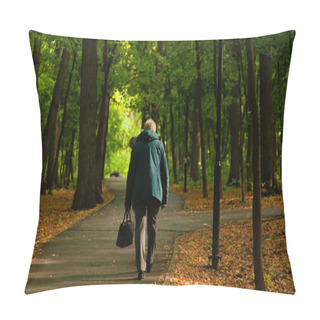 Personality  An Old Hunched Woman In Pants And A Jacket Walks Along The Road In The Park. The Image Of The Inevitability Of Aging Pillow Covers