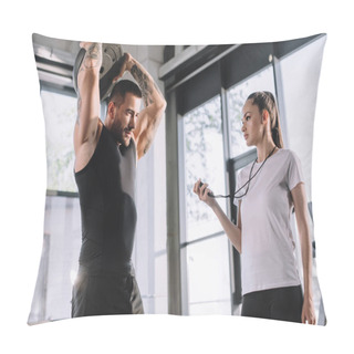 Personality  Female Personal Trainer Using Timer While Sportsman Doing Exercises With Barbell Disc At Gym Pillow Covers