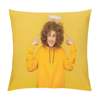 Personality  Portrait Of Charming Angel With Halo, Kind Curly-haired Hipster Woman Pointing At Saint Nimbus Over Her Head And Smiling With Obedient Modest Expression. Studio Shot Isolated On Yellow Background Pillow Covers