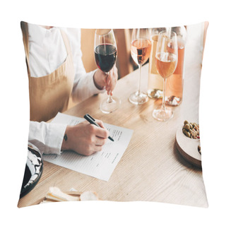 Personality  Cropped View Of Sommelier In Apron Sitting At Table, Holding Wine Glass And Writing In Wine Tasting Document Pillow Covers