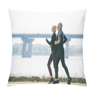 Personality  Mature Sportsman And Sportswoman Running Along Riverside In Park Pillow Covers