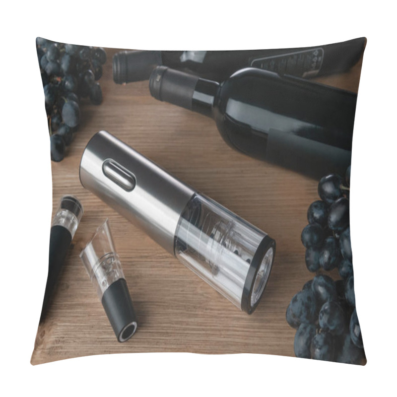 Personality  Electronic cordless corkscrew metallic. On a wooden background. Near the aerator and the vacuum stopper for the bottle. In the background grapes  and a bottle of wine. pillow covers