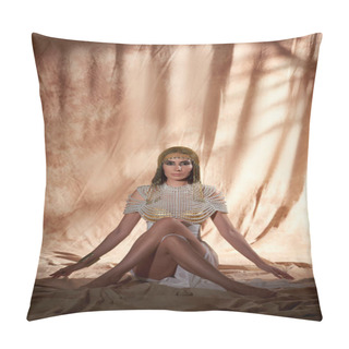 Personality  Stylish Brunette Woman In Egyptian Attire And Makeup Posing While Sitting On Abstract Background Pillow Covers