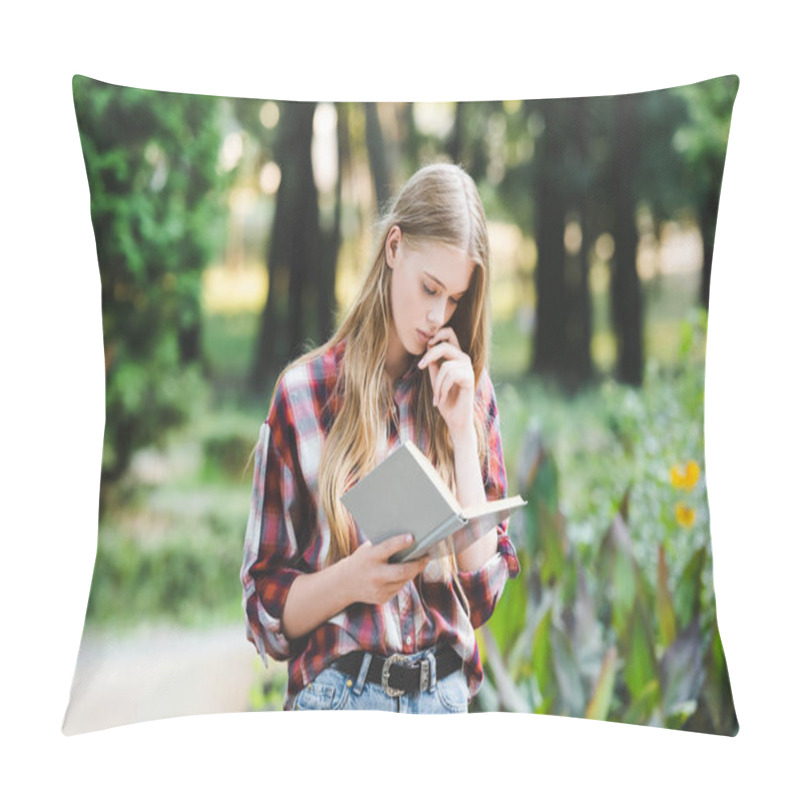 Personality  focused young girl in casual clothes reading book pillow covers