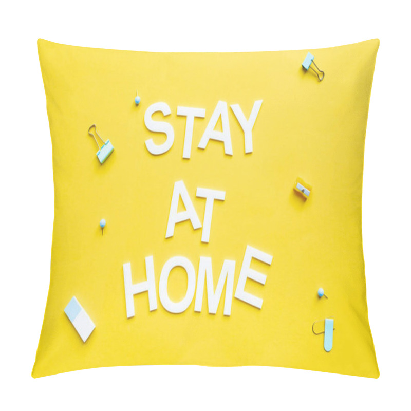 Personality  Top view of stay at home lettering near binder clips and pencil sharpener on yellow surface pillow covers