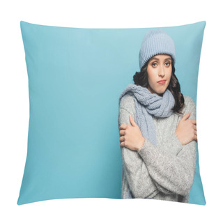 Personality  Sad Brunette Woman In Hat And Scarf Hugging Herself While Looking At Camera Isolated On Blue Pillow Covers