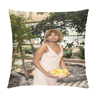 Personality  Portrait Of Modern African American Woman In Summer Dress Holding Basket With Fresh Lemons And Looking Away And Standing Near Plants In Orangery, Fashion-forward Lady In Harmony With Tropical Flora Pillow Covers