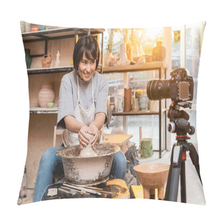 Personality  Young And Cheerful Asian Artist In Apron Molding Clay On Pottery Wheel Near Tools And Looking At Blurred Digital Camera On Tripod In Workshop At Sunset, Artisan Creating Unique Pottery Pieces Pillow Covers