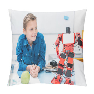 Personality  Smiling Schoolboy Sitting At Table And Looking At Robot Model During STEM Lesson   Pillow Covers
