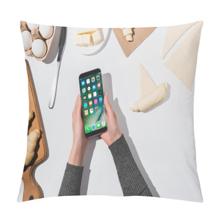 Personality  KYIV, UKRAINE - APRIL 22, 2019: Cropped View Of Woman Holding IPhone While Cooking Croissant On White Background Pillow Covers