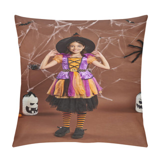 Personality  Happy Girl In Halloween Costume Adjusting Witch Hat And Standing Near Cobwebs On Brown Backdrop Pillow Covers
