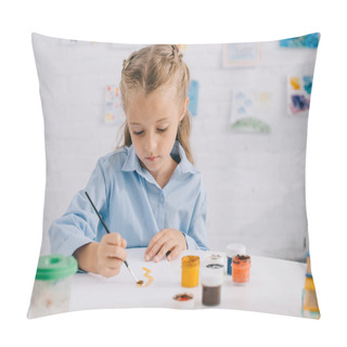 Personality  Portrait Of Adorable Focused Child Drawing Picture With Paints And Brush At Table Pillow Covers
