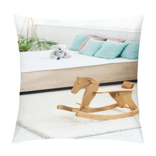 Personality  Selective Focus Of Wooden Rocking Horse Near Bed With White Bedding, Pillows And Teddy Bear Pillow Covers