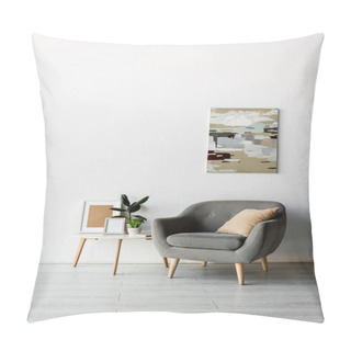 Personality  Grey Armchair Near Coffee Table With Frames And Green Plants Near Painting On Wall In Modern Living Room  Pillow Covers