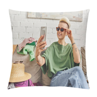 Personality  Carefree Tattooed Woman With Trendy Hairstyle Taking Selfie In Sunglasses On Smartphone Near Clothes And Straw Hat On Couch In Living Room, Sustainable Living And Mindful Consumerism Concept Pillow Covers