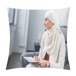 Personality  Beautiful Young Muslim Woman Sitting In Chair With Notepad And Looking Away Pillow Covers