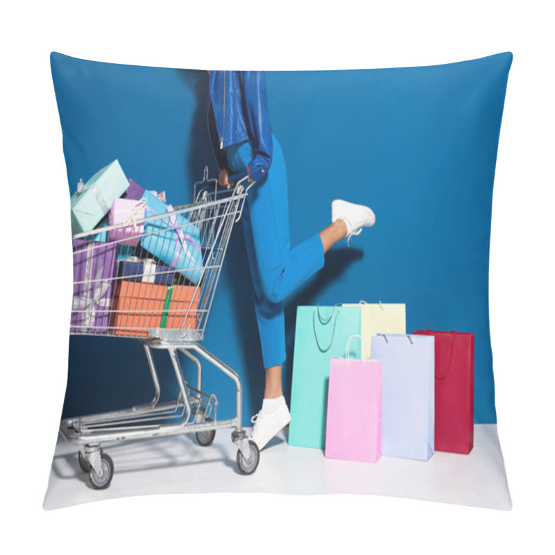 Personality  Cropped View Of African American Woman With Shopping Cart Full Of Gifts Near Shopping Bags On Blue Background Pillow Covers