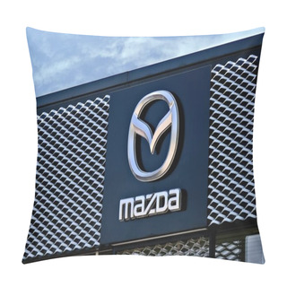 Personality  Neu-Ulm, Bavaria, Germany - June, 14, 2023: Mazda Car Dealership Sign Against Cloudy Sky. Pillow Covers