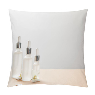 Personality  Different Sized Cosmetic Glass Bottles And Few Jasmine Flowers On Beige Pillow Covers