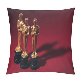 Personality  KYIV, UKRAINE - JANUARY 10, 2019: Selective Focus Of Golden Oscar Award Statuettes On Red Background With Copy Space Pillow Covers